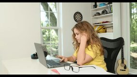 Kid studying mathematics on laptop during e-learning session. Student streaming lesson on modern technology. Child doing schoolwork in home classroom interior. Online education and digital study. - Powered by Shutterstock - Get 15% off with code: PIKWIZARD15