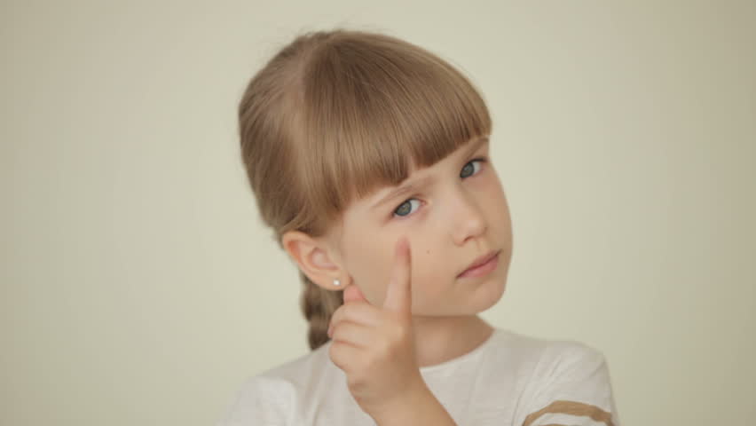 Girl waving her finger and looking at camera serious
