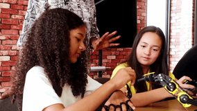 Happy kids celebrate success in a robotics classroom, high-fiving their teacher after completing a STEM coding project. Diverse group with teamwork and innovation spirit in educational tech learning. - Powered by Shutterstock - Get 15% off with code: PIKWIZARD15