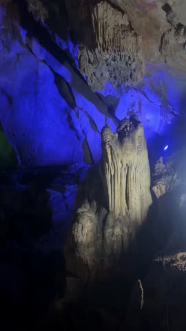 Wang Vieng, Laos.Tham Jang Cave-stalactites and stalagmites in a karst mountain with a Buddha temple inside. There is a spring inside the cave. The cave is equipped with comfortable paths and lanterns