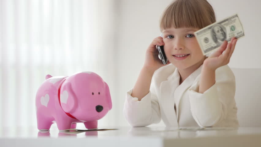 Little  businesslady talking on the phone and holding money in hand
