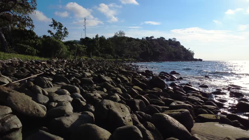 Rocky beach coastline wild ocean waves ripples Cambodia Southeast Asia
