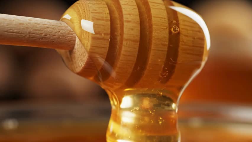 Golden honey dripping from a wooden dipper a sweet and natural treat - Powered by Shutterstock - Get 15% off with code: PIKWIZARD15