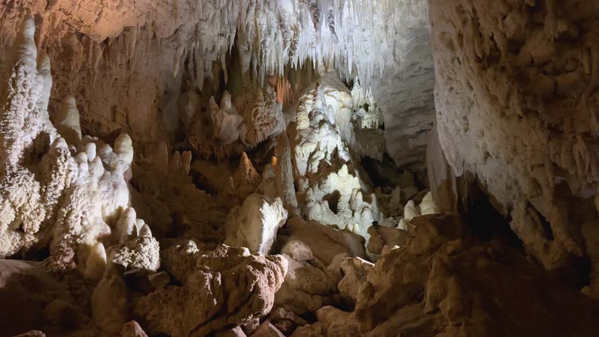 Stalagmites and stalactites create a dramatic underground scene in Waitomo Caves, New Zealand’s North Island. Stunning rock formations and natural patterns make this cave unique.