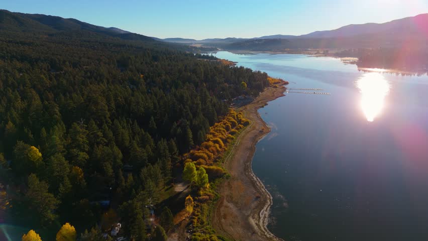 Drone aerial view of mountain lake and forest landscape in California