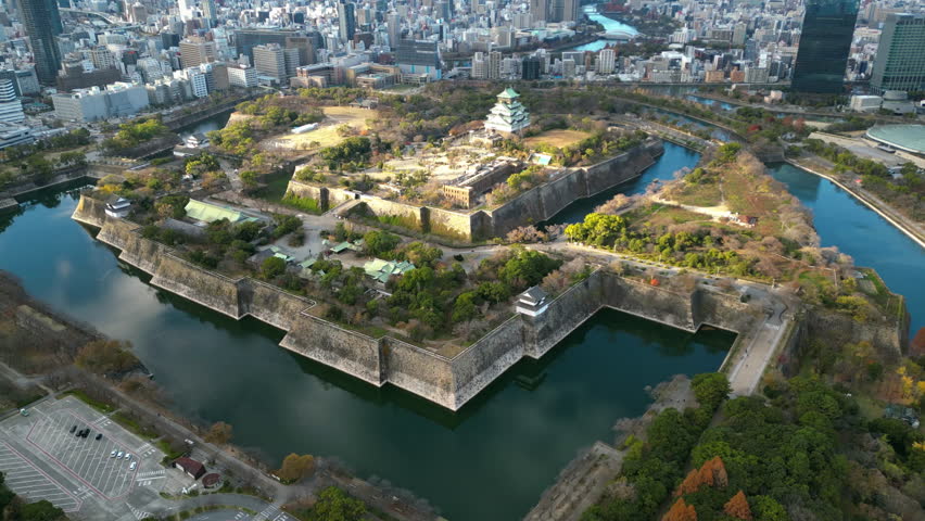 Aerial view tilting toward the Osaka castle, sunny, autumn day in Japan