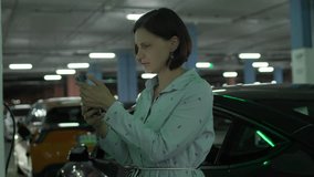 Woman Struggling with Car Charging App at Electric Charging Station - Powered by Shutterstock - Get 15% off with code: PIKWIZARD15
