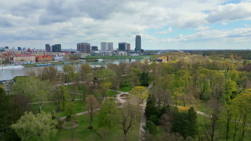An serial view of Bratislava skyline with Danube River and Janko Kral Park under cloudy spring sky