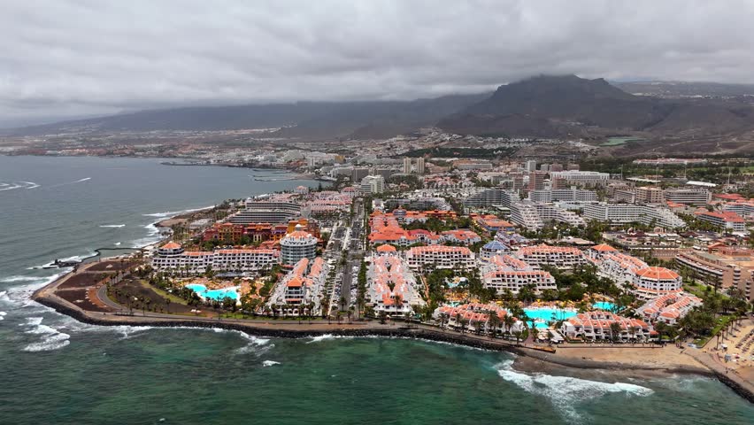The town on the coast, cloudy days, mountains on a background