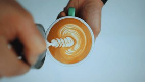 Rosetta free-pour latte art created with smooth macrofoam, showcasing skilled barista technique and elegant coffee artistry in a crafted cup. - Powered by Shutterstock - Get 15% off with code: PIKWIZARD15