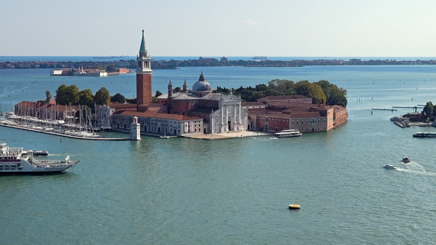 San Giorgio Maggiore Island in Venetian Lagoon, church, bell tower and boats in Venice, Italy