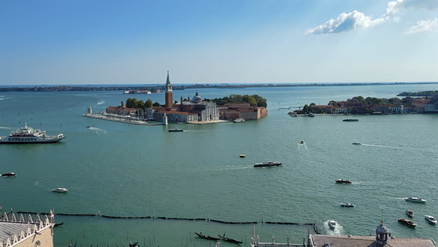 high angle wide view of Venice Lagoon and San Giorgio Maggiore island, turquoise water and boats