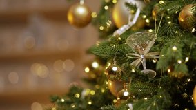 Golden ornaments and lights on festive christmas tree with decorative pine cones. - Powered by Shutterstock - Get 15% off with code: PIKWIZARD15