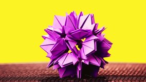 Beautiful origami paper flower displayed on a bright yellow background, highlighting delicate craftsmanship, vibrant color, and artistic paper design. - Powered by Shutterstock - Get 15% off with code: PIKWIZARD15