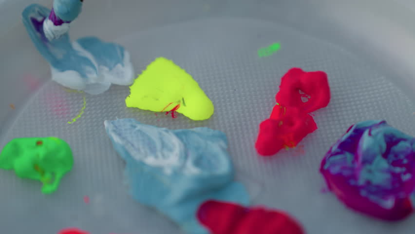 high angle shot of hand dipping paint brush into neon paint globs on plastic palette set on wooden bench by river at sunset capturing vibrant mixing process in serene outdoor creative art session - Powered by Shutterstock - Get 15% off with code: PIKWIZARD15