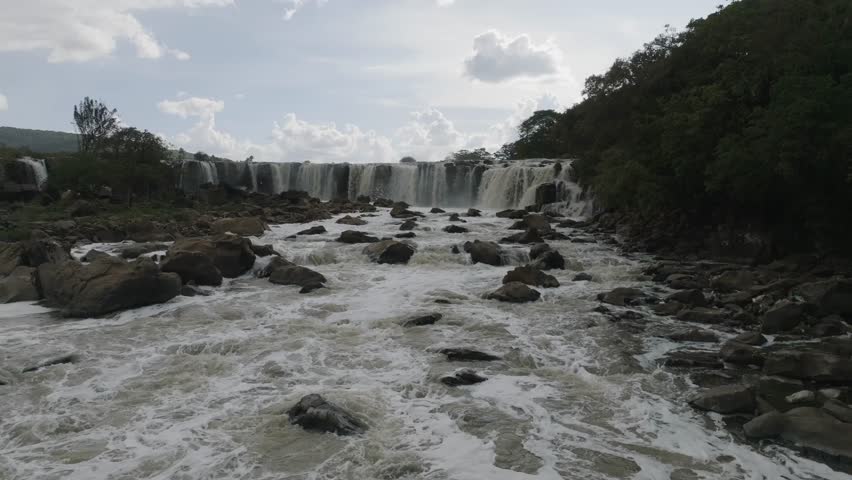 Aerial view of the powerful waterfalls cascading into the turbulent river rapids, creating a dynamic display of nature's force, Kilimambogo, Kiambu County, Kenya.