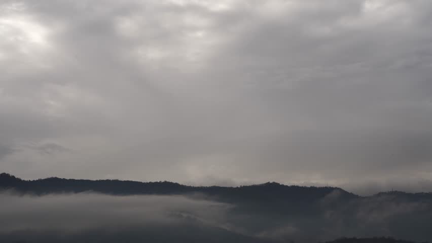 Moody dark sky over mountain peaks timelapse