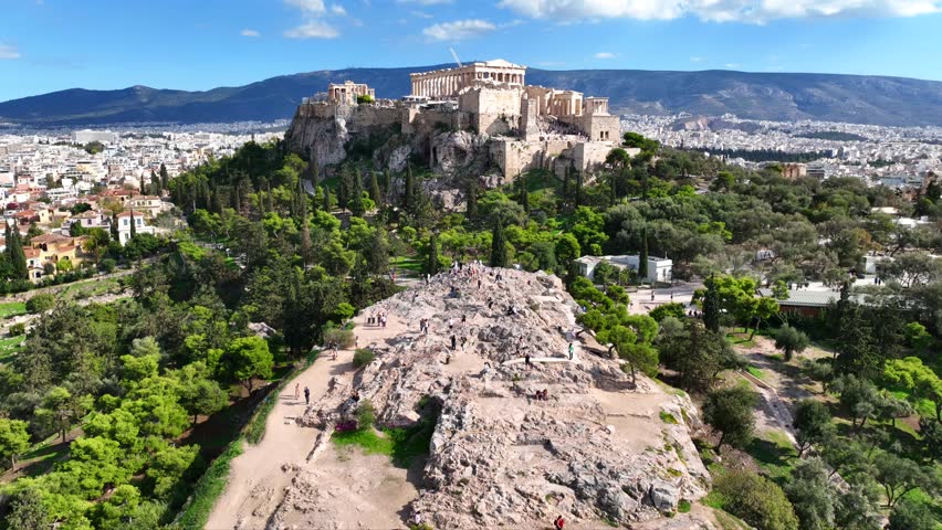Aerial drone cinematic video of iconic Acropolis hill and the Parthenon featuring Erechtheion and Porch of the Caryatids, Athens historic centre, Attica, Greece
