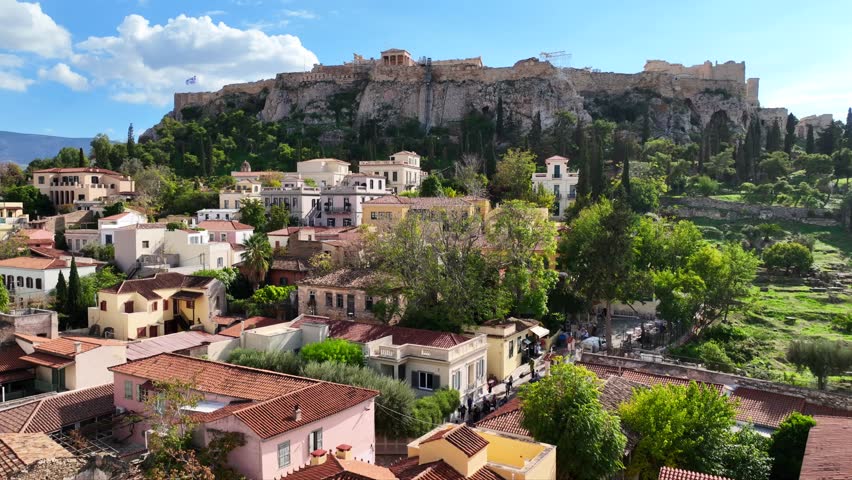 Aerial drone cinematic video of iconic Roman Market featuring tower of Winds and Gate of Athena in the heart of Athens historic centre built in Plaka district, below Acropolis hill, Attica, Greece
