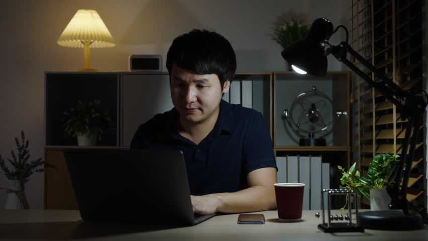 success man working with laptop at a night