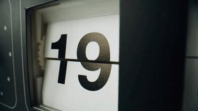 Closeup macro view of an electromechanical clock calendar with split-flap panels changing date and time, symbolizing precision, timekeeping, and modern engineering. - Powered by Shutterstock - Get 15% off with code: PIKWIZARD15