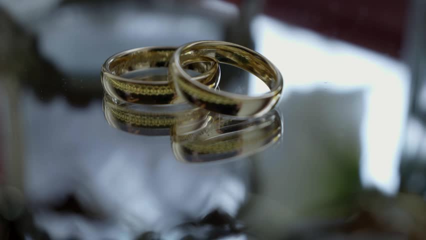 Luxury Gold Wedding Bands on Transparent Table Detail