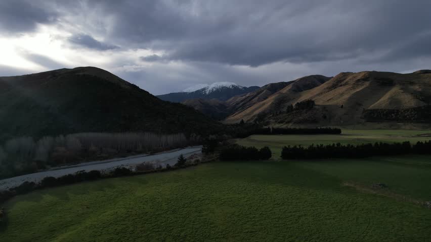 Cinematic 4K aerial footage of a drone flying smoothly over the Southern Alps in New Zealand. Crisp morning light, dramatic ridgelines, and distant valleys create an epic natural landscape. Ideal for 