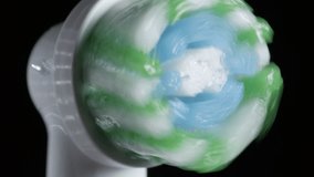 Water droplets fly from wet vibrating brush head of electric toothbrush, closeup - Powered by Shutterstock - Get 15% off with code: PIKWIZARD15