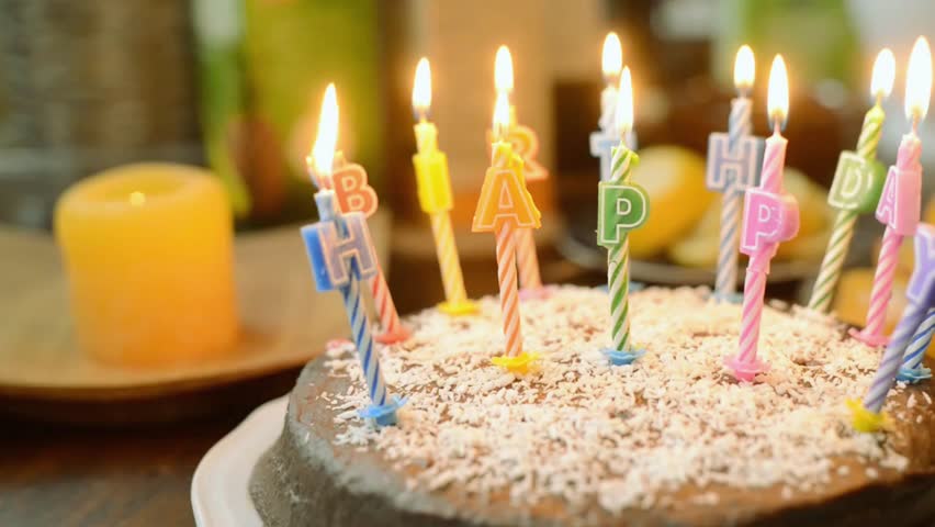 Delicious birthday cake topped with glowing candles and “Happy Birthday” inscription. Perfect for celebrations, parties, and joyful dessert visuals that capture festive and cheerful birthday moments.
