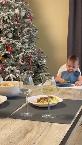 Baby Eating Near Christmas Tree Copy Space
