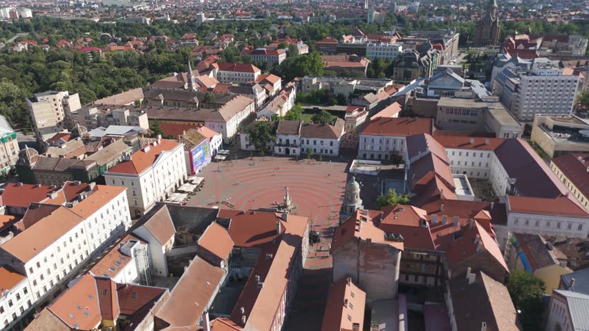 Drone tilt-down shot of Liberty Square, showcasing the architectural beauty and vibrant atmosphere of Timișoara’s historic center.