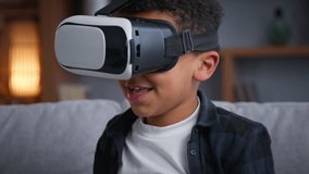 Little African American funny boy in VR helmet playing fighting smiling carefree son kid child at home play video game using augmented virtual reality metaverse enjoying modern technology - Powered by Shutterstock - Get 15% off with code: PIKWIZARD15
