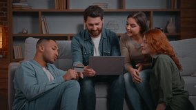 Excited multiracial four friends shopping online together ordering food delivery for home party on couch diverse men women using credit card internet payment on laptop celebrate success money cashback - Powered by Shutterstock - Get 15% off with code: PIKWIZARD15
