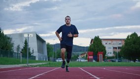 Athlete with a disability wearing a running prosthetic training on an athletic field outdoors, front view. Orthopedic equipment and active lifestyles concept. - Powered by Shutterstock - Get 15% off with code: PIKWIZARD15