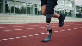 Man with a running prosthesis, a prosthetic leg with a blade, training on an athletic track, slow motion. Disabilities and active lifestyle concept. - Powered by Shutterstock - Get 15% off with code: PIKWIZARD15