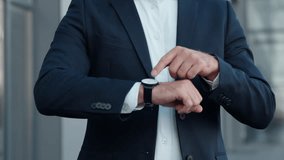 Closeup unrecognizable business man pointing on wristwatch checking time late in city unknown businessman male employer entrepreneur manager corporate meeting lateness executive with wrist smart watch - Powered by Shutterstock - Get 15% off with code: PIKWIZARD15