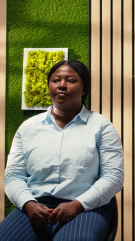 Vertical Video Candidates in the hallway receive forms from HR secretary with a trolley, participating in the recruitment process and waiting in line to fill in job interview details. Workplace