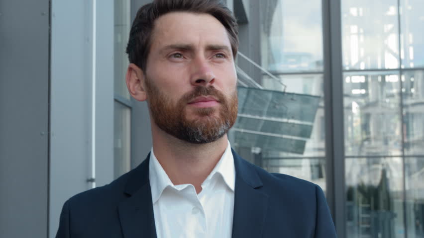 Middle-aged pensive Caucasian businessman outside walking business man walk in city near office building going to company near glass wall contemplating male executive go in downtown moving to work