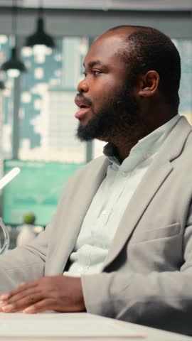 Vertical Video HR team conduct CV evaluation with candidate during job interview in a business space, analyzing work experience and qualifications for career development. Talent acquisition. Camera B.