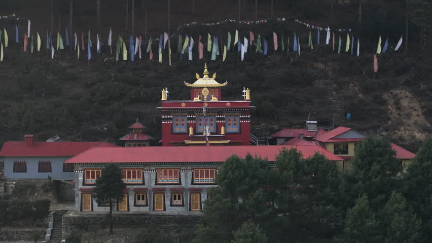 Aerial telezoom approaching the Phakding Monastery, in hazy Sagarmatha, Nepal
