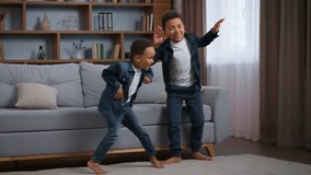 Two African American boys little children dancing at home joyful funny moving to music happy family kids sons brothers dance to song siblings fooling around having fun smiling playing laughing - Powered by Shutterstock - Get 15% off with code: PIKWIZARD15