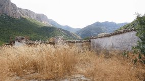 Abandoned cemetery of Otiñar (Jaén), with ruins and tombs at the foot of a large rocky mountain. - Powered by Shutterstock - Get 15% off with code: PIKWIZARD15