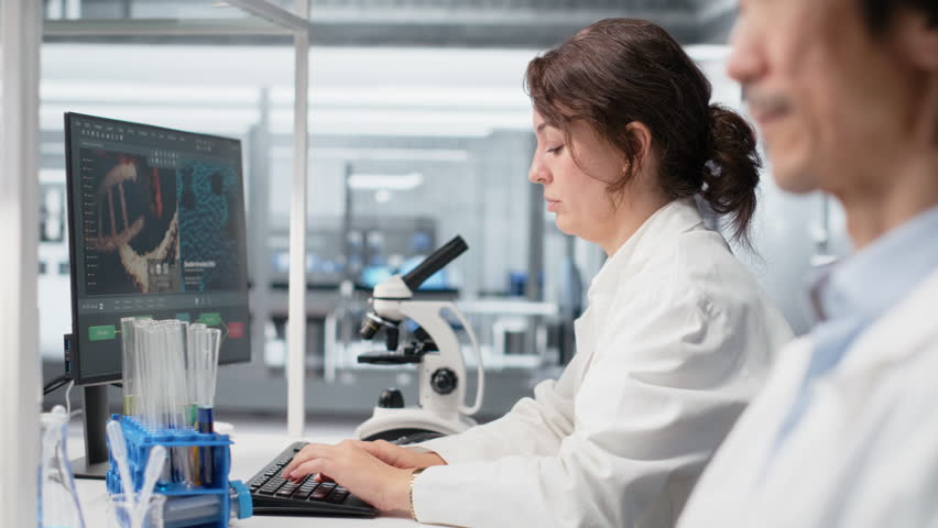 Clinical microbiologist checking time, waiting to finish shift, processing patient data. Diagnostic laboratory manager using PC to do genetic analysis diagnostics checking wrist watch clock - Powered by Shutterstock - Get 15% off with code: PIKWIZARD15
