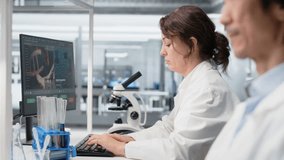 Clinical microbiologist checking time, waiting to finish shift, processing patient data. Diagnostic laboratory manager using PC to do genetic analysis diagnostics checking wrist watch clock - Powered by Shutterstock - Get 15% off with code: PIKWIZARD15