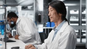 Laboratory technician using computer application for DNA data analysis, doing research into human health. Asian lab engineer using bioinformatics genomics software on PC, camera B - Powered by Shutterstock - Get 15% off with code: PIKWIZARD15
