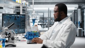 High tech lab technician at desk typing on PC keyboard, looking at molecular model, doing research tasks. African american man using bioengineering program on PC in medical lab, camera B - Powered by Shutterstock - Get 15% off with code: PIKWIZARD15