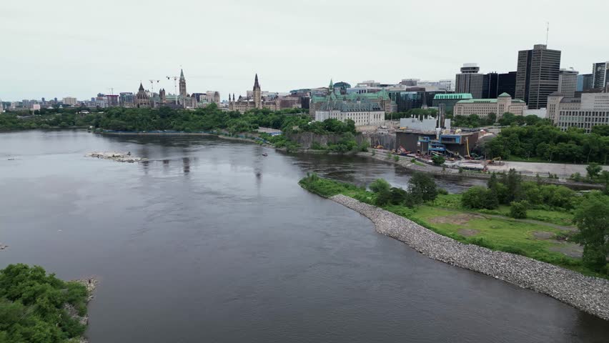 City of Ottawa on a river with Parliament buildings supreme court of Canada downtown. Tracking in aerial shot.