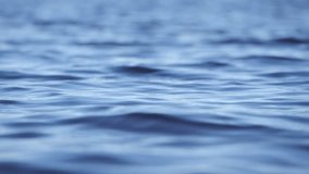 Rippling water surface, peaceful scene. Close up, slow motion. - Powered by Shutterstock - Get 15% off with code: PIKWIZARD15