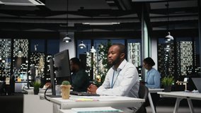 Black business people working together on report writing in dark office, collaborating on building a new development strategy after hours. Reviewing insights to enhance efficiency. Camera A. - Powered by Shutterstock - Get 15% off with code: PIKWIZARD15