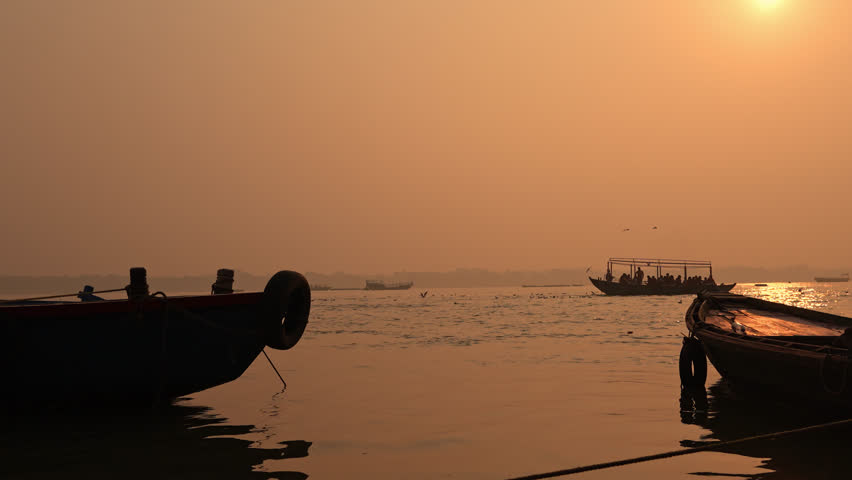 Beautiful sunrise view over the sacred Ganga River in Varanasi. The golden-orange sky and calm reflections on the water capture the peaceful energy of India’s spiritual heart.